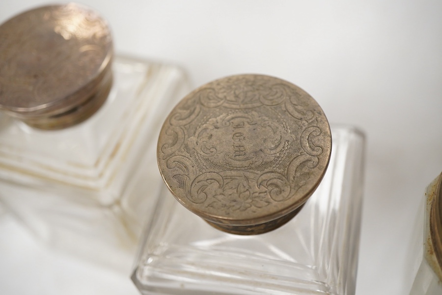 A George V silver and enamel five piece dressing table set (a.f.), together with four Victorian engraved silver topped glass toilet bottles